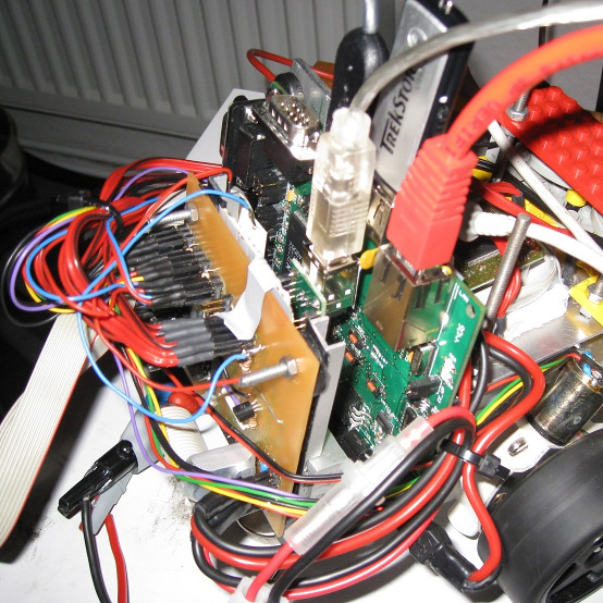 Our robot, mostly consisting of a mess of wires, a home etched PCB and an embedded Linux development board.